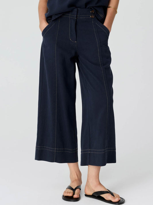 Image of a model wearing Pants. Product name - Pol Anise Crop Pant in Ink colour by brand - Pol