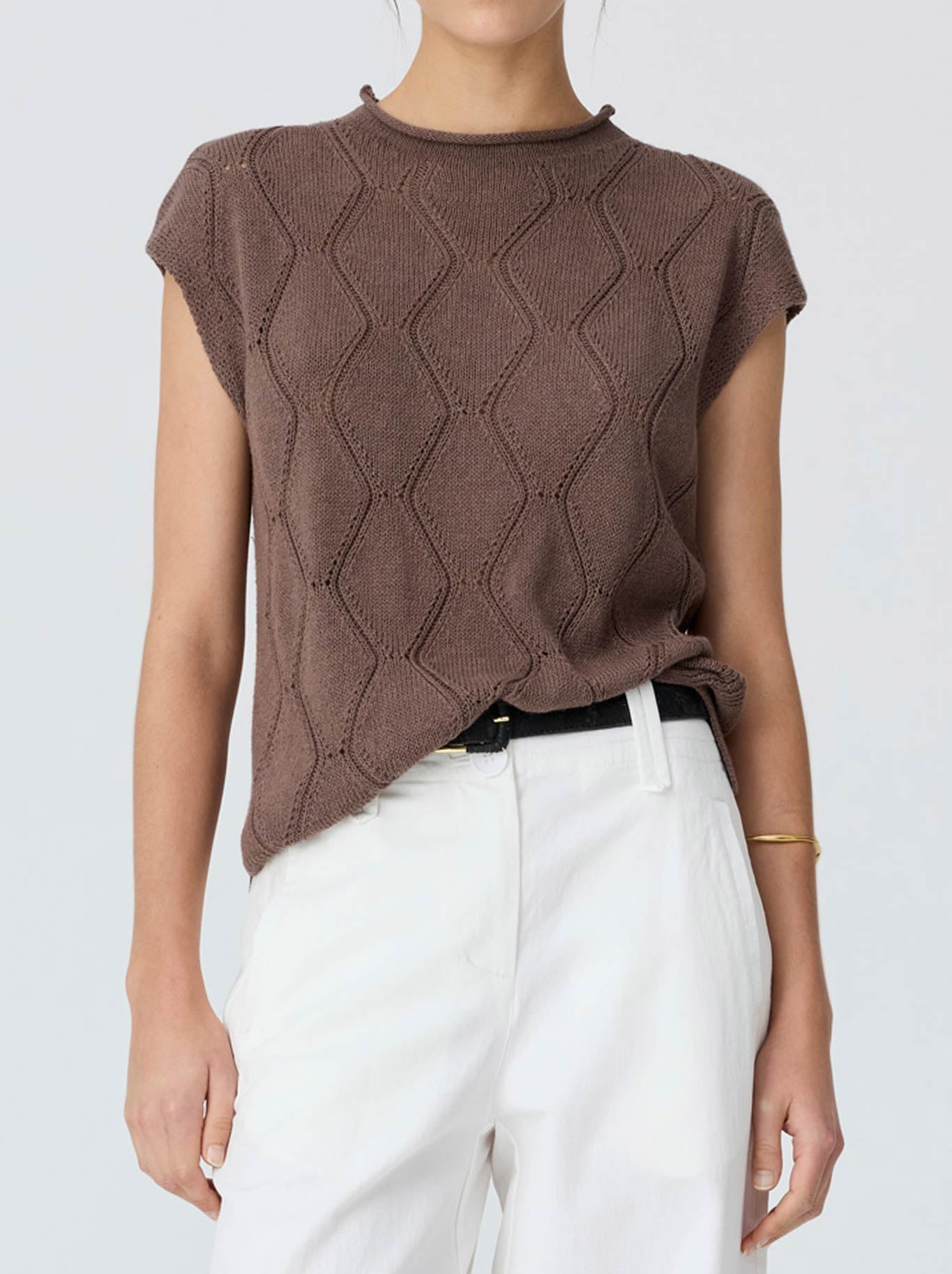 Image of a model wearing Outerwear. Product name - Pol Rosin Cable Knit in Chocolate colour by brand - Pol