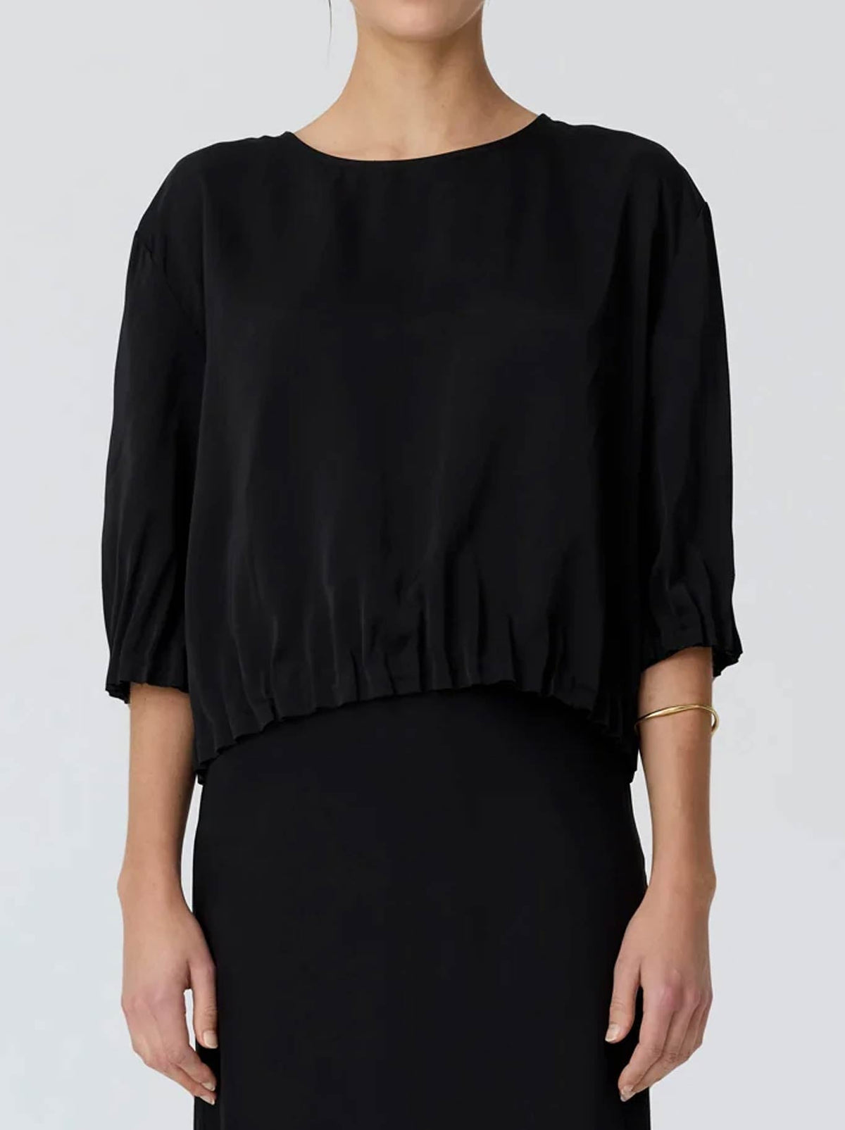 Image of a model wearing Tops. Product name - POL INNES TUCK TOP in Black colour by brand - Pol