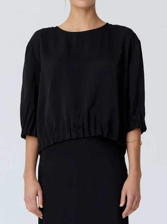 Image of a model wearing Tops. Product name - POL INNES TUCK TOP in Black colour by brand - Pol