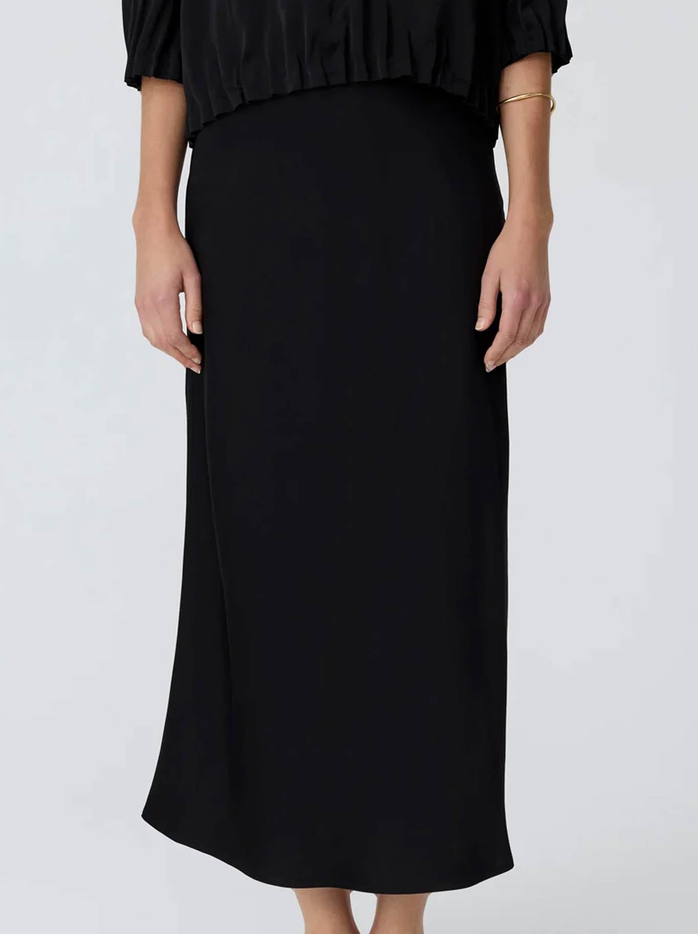 Image of a model wearing Skirts. Product name - POL INNES BIAS SKIRT in Black colour by brand - Pol