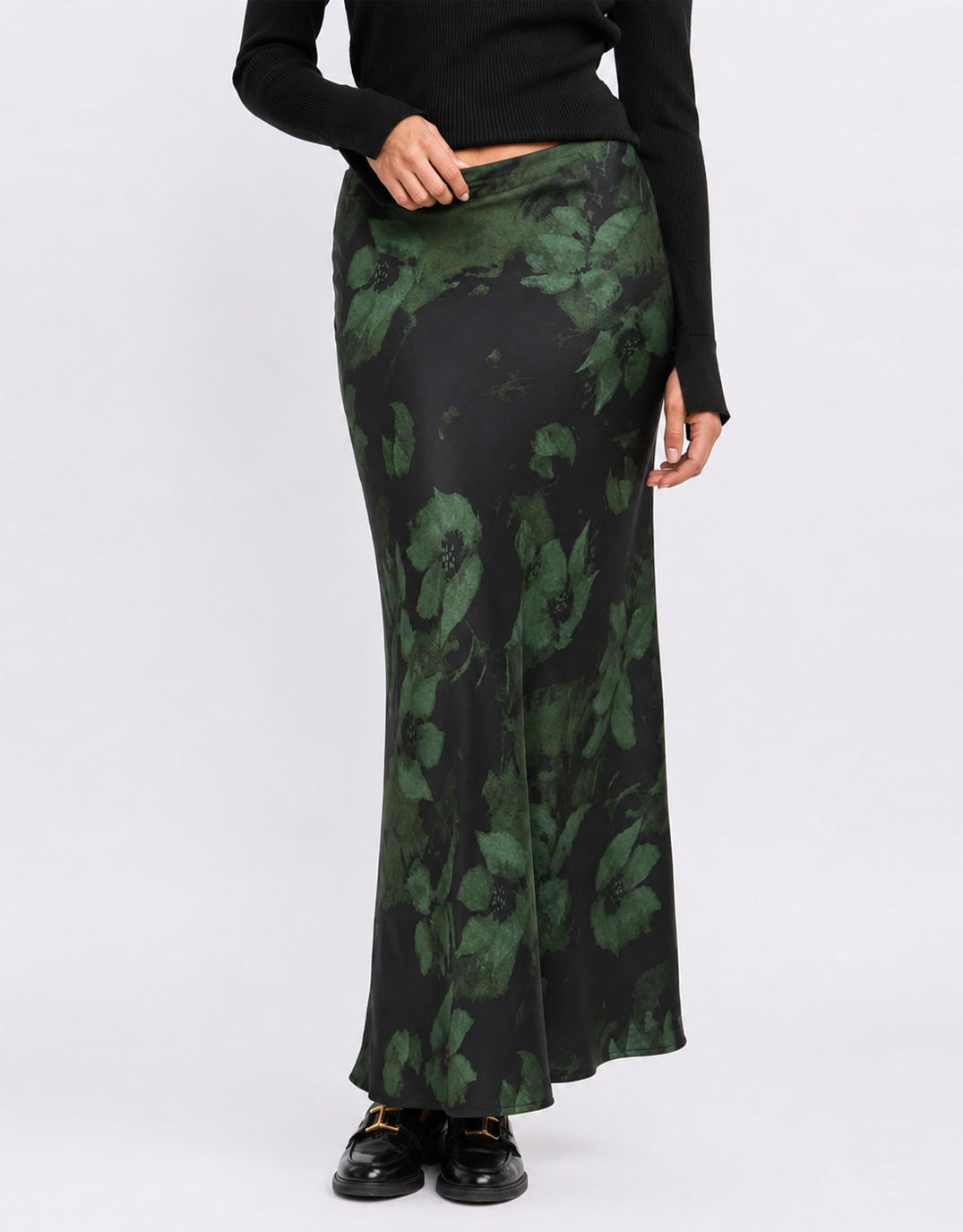 Image of a model wearing Skirts. Product name - Prodigy Satin Bias Cut Maxi Skirt Green Shadow Garden in Green Shadow Garden colour by brand - Stories Be Told