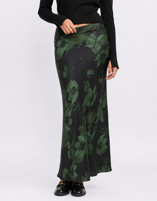 Image of a model wearing Skirts. Product name - Prodigy Satin Bias Cut Maxi Skirt Green Shadow Garden in Green Shadow Garden colour by brand - Stories Be Told
