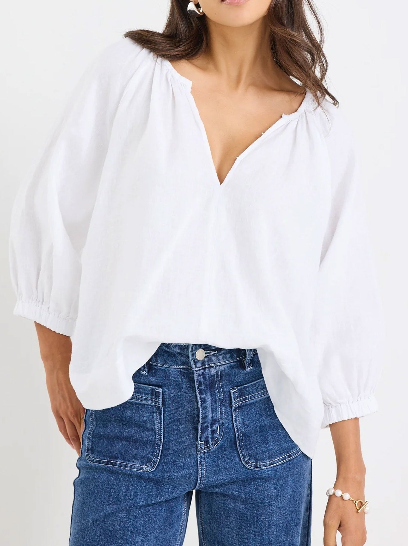 Image of a model wearing Tops. Productname: RE:UNION THE LABEL REVOLUTIONARY LINEN TOP in White colour by brand - Re:Union The Label