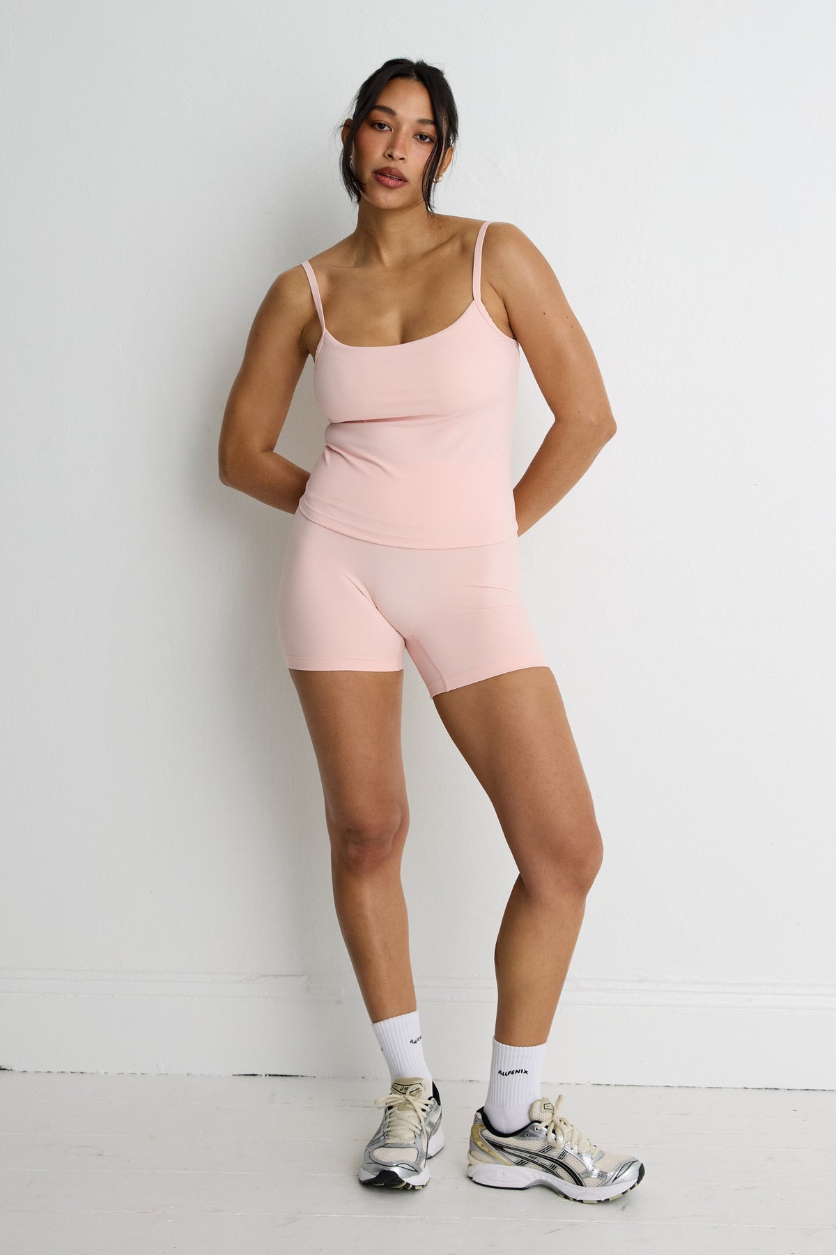 Image of a model wearing Tops. Product name - NEW ALLFENIX CloudCore Sculpt Tank in Tan colour by brand - All Fenix