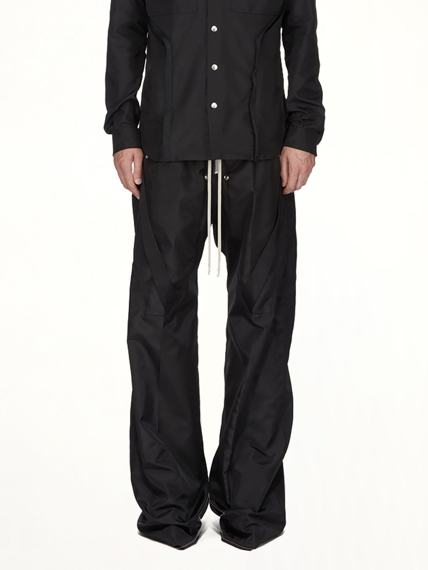 Image of a model wearing Pants. Product name - Strapped Wide Bela Pants in Black colour by brand - RICK OWENS