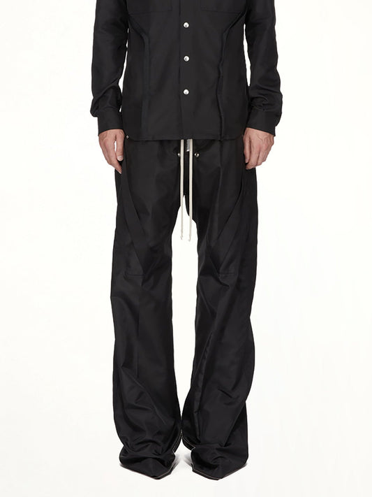 Image of a model wearing Pants. Product name - Strapped Wide Bela Pants in Black colour by brand - RICK OWENS