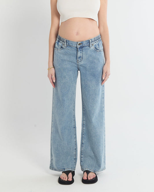 Image of a model wearing Pants. Product name - Relaxed Wide Leg Jeans in colour by brand - Soon Maternity