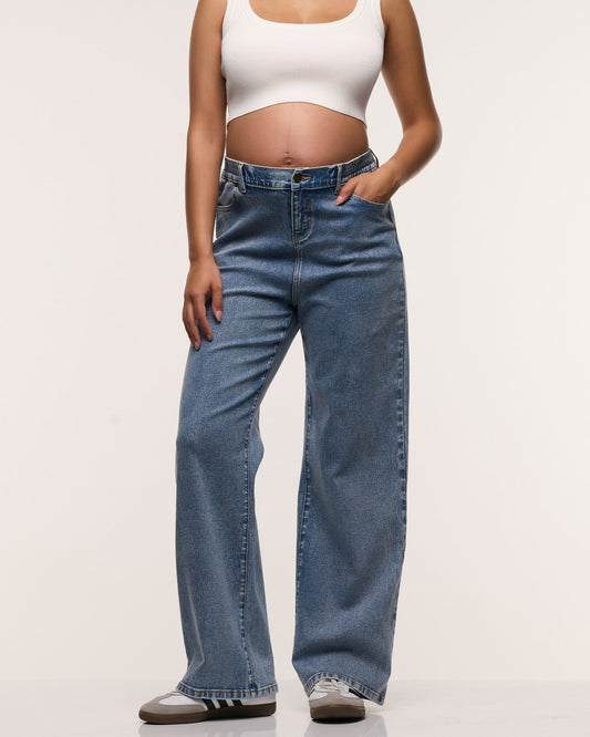 Image of a model wearing Pants. Product name - Relaxed Wide Leg Jeans in colour by brand - Soon Maternity
