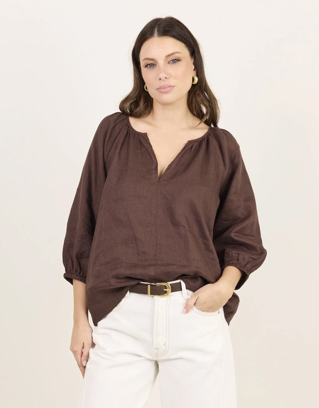 Image of a model wearing Tops. Product name - Revolutionary Linen Relaxed LS Top Chocolate in Chocolate colour by brand - Re:Union The Label