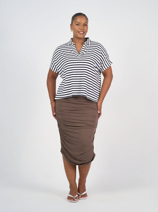 Image of a model wearing Skirts. Product name - Ross Ruched Bamboo Midi Tube Skirt Chocolate in Chocolate colour by brand - Lou Lou