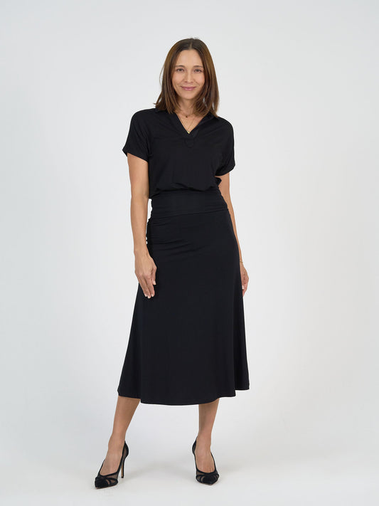 Image of a model wearing Tops. Product name - Rush Bamboo Short Sleeve Collared Polo Black in Black colour by brand - Lou Lou
