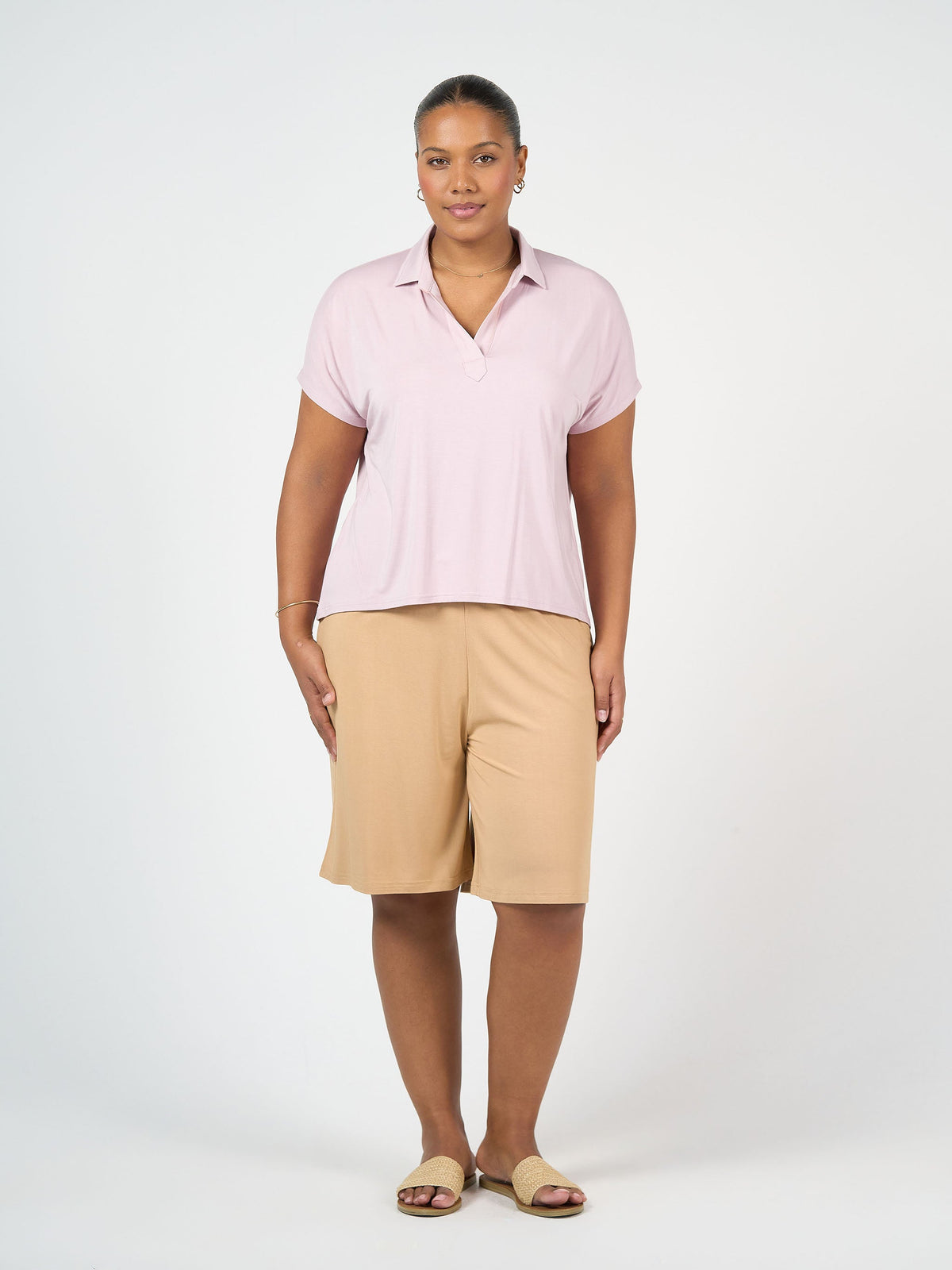 Image of a model wearing Tops. Product name - Rush Bamboo Short Sleeve Collared Polo Top in Black colour by brand - Lou Lou