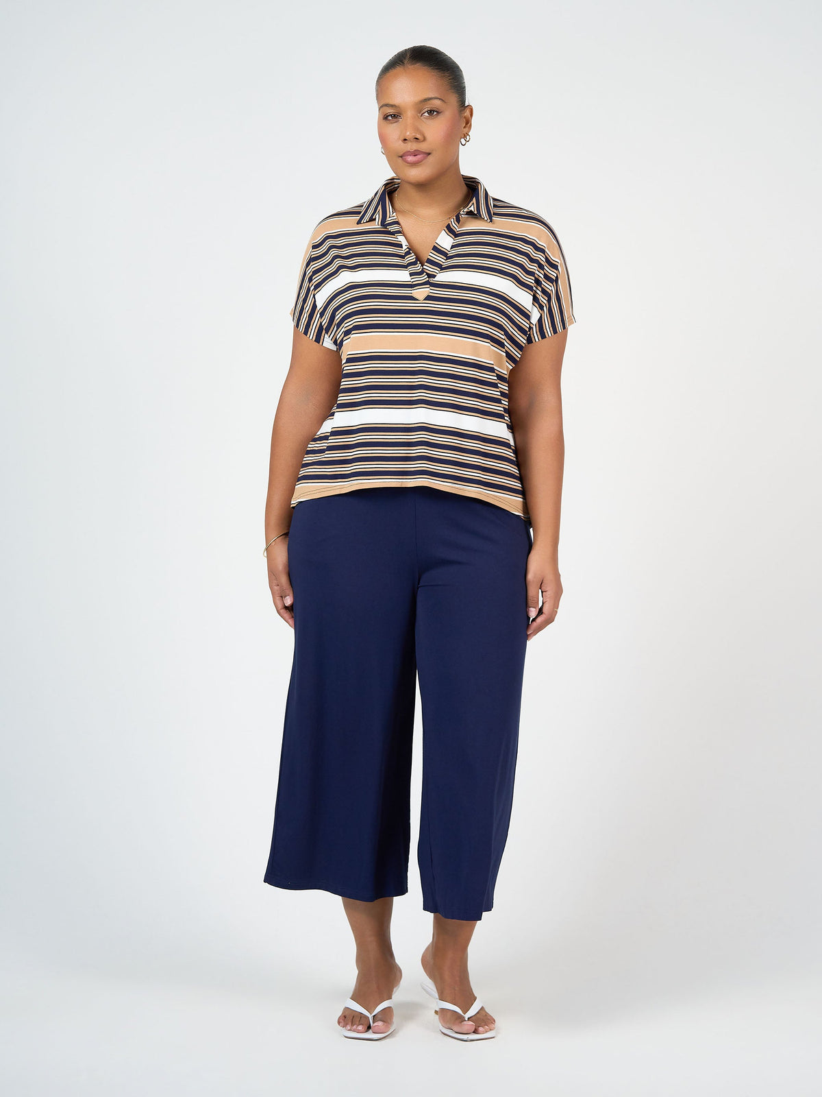 Image of a model wearing Tops. Product name - Rush Bamboo Short Sleeve Collared Polo Top Stripe in Stripe colour by brand - Lou Lou