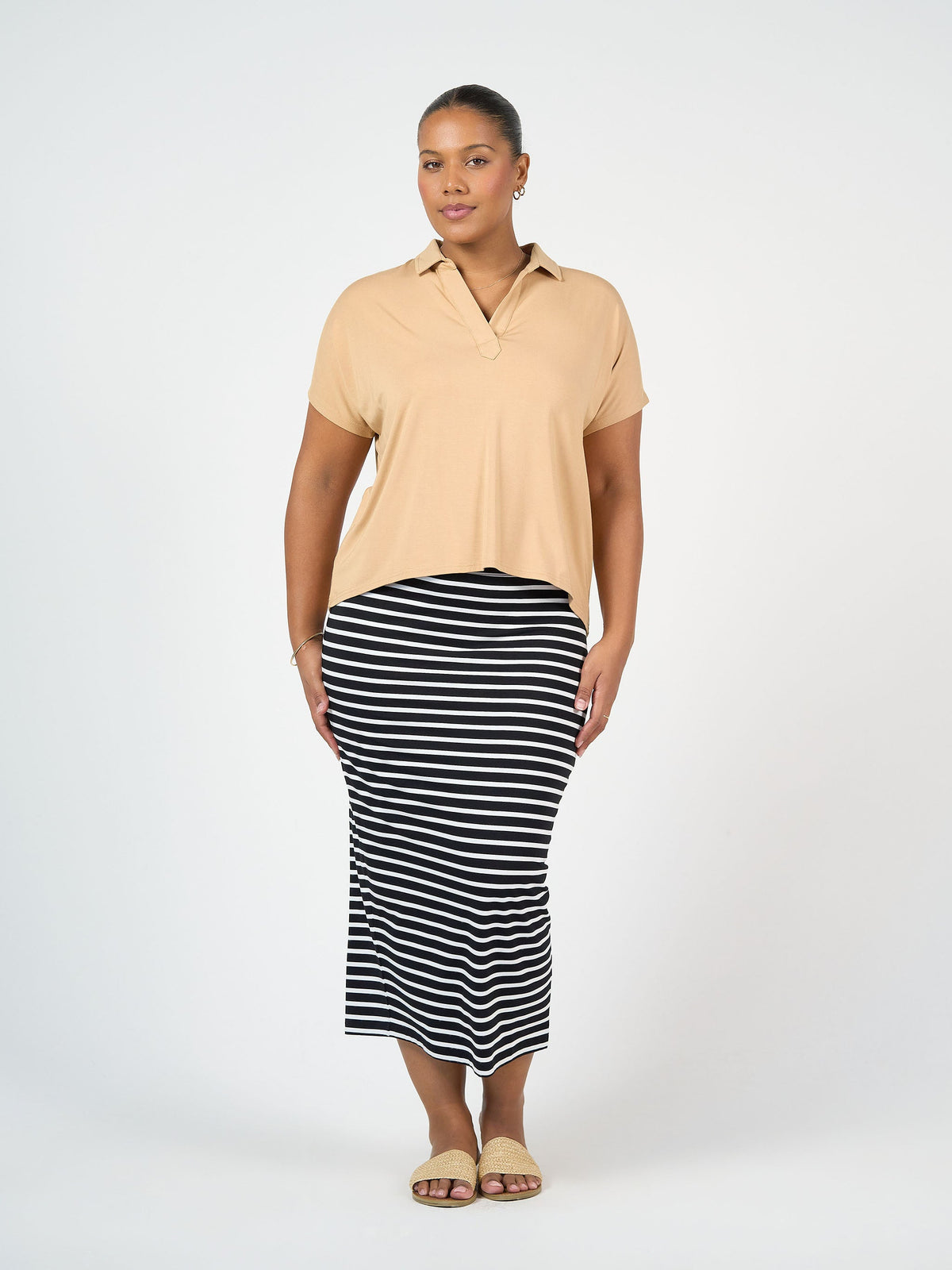 Image of a model wearing Tops. Product name - Rush Bamboo Short Sleeve Collared Polo Top Tan in Tan colour by brand - Lou Lou