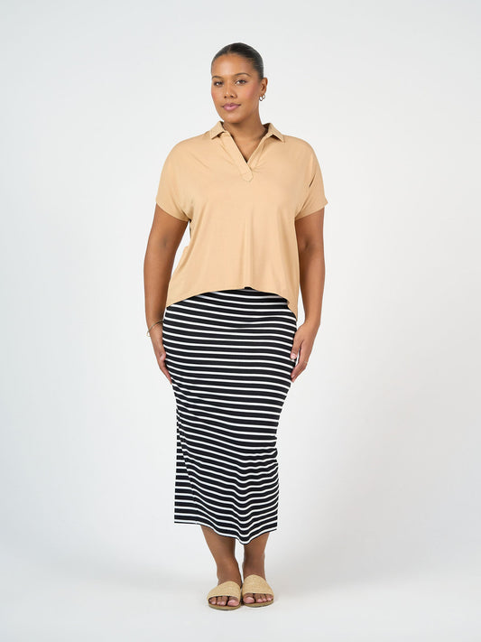Image of a model wearing Tops. Product name - Rush Bamboo Short Sleeve Collared Polo Top Tan in Tan colour by brand - Lou Lou