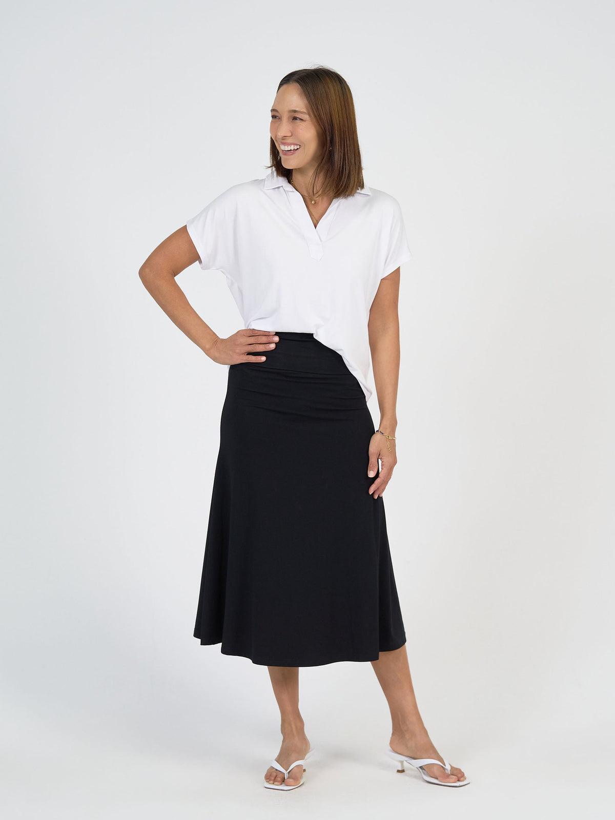 Image of a model wearing Tops. Product name - Rush Bamboo Short Sleeve Collared Polo Top White in White colour by brand - Lou Lou