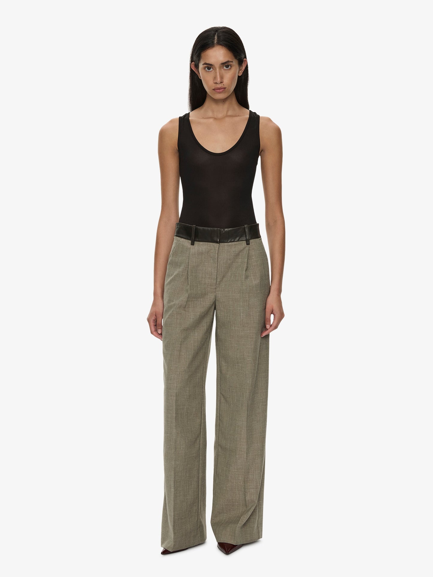 Image of a model wearing Pants. Product name - Tropical Wool Leather Waisted Trouser in Kombu colour by brand - CHRISTOPHER ESBER