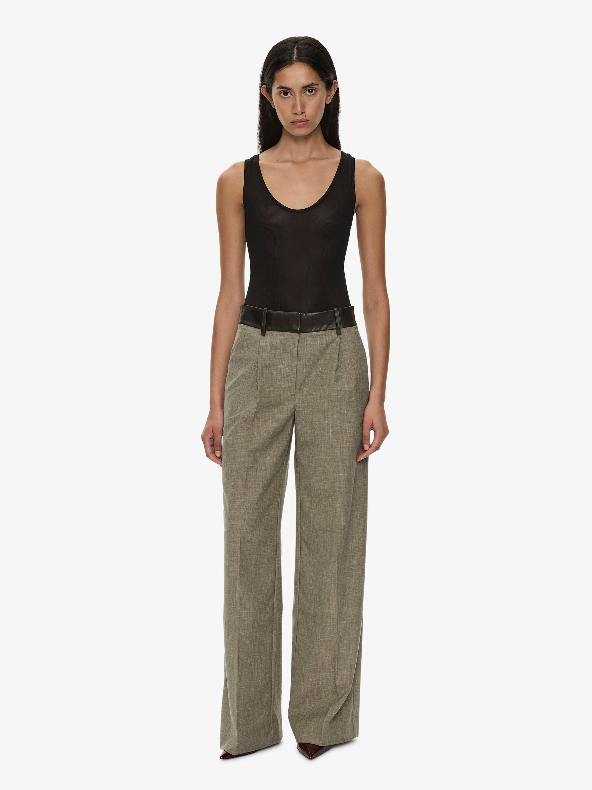 Image of a model wearing Pants. Product name - Tropical Wool Leather Waisted Trouser in Kombu colour by brand - CHRISTOPHER ESBER