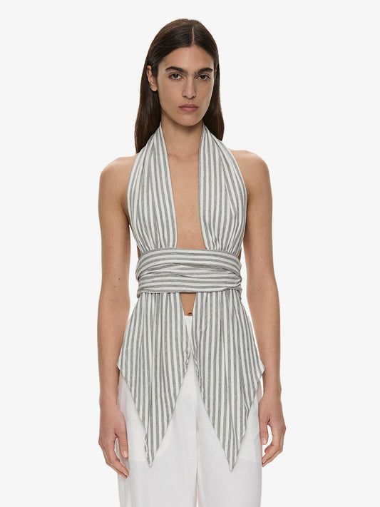 Image of a model wearing Tops. Product name - Scarf Draped Halter Top in Stripe colour by brand - CHRISTOPHER ESBER