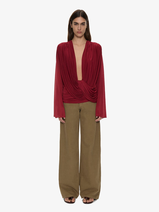 Image of a model wearing Tops. Product name - Ripple Drape Long Sleeve Top in Wine colour by brand - CHRISTOPHER ESBER