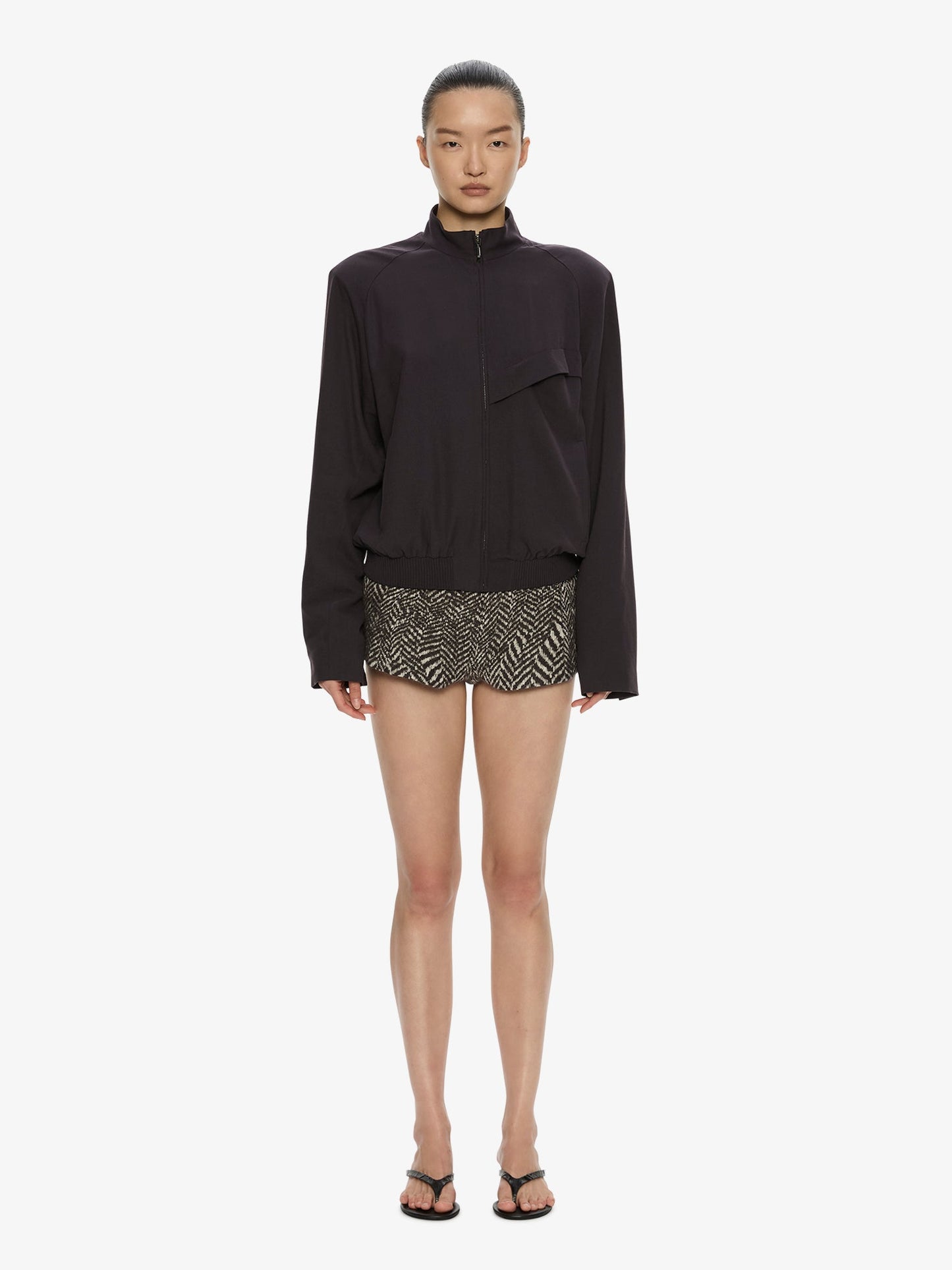 Image of a model wearing Shorts. Product name - Warped Herringbone Tailored Short in White colour by brand - CHRISTOPHER ESBER