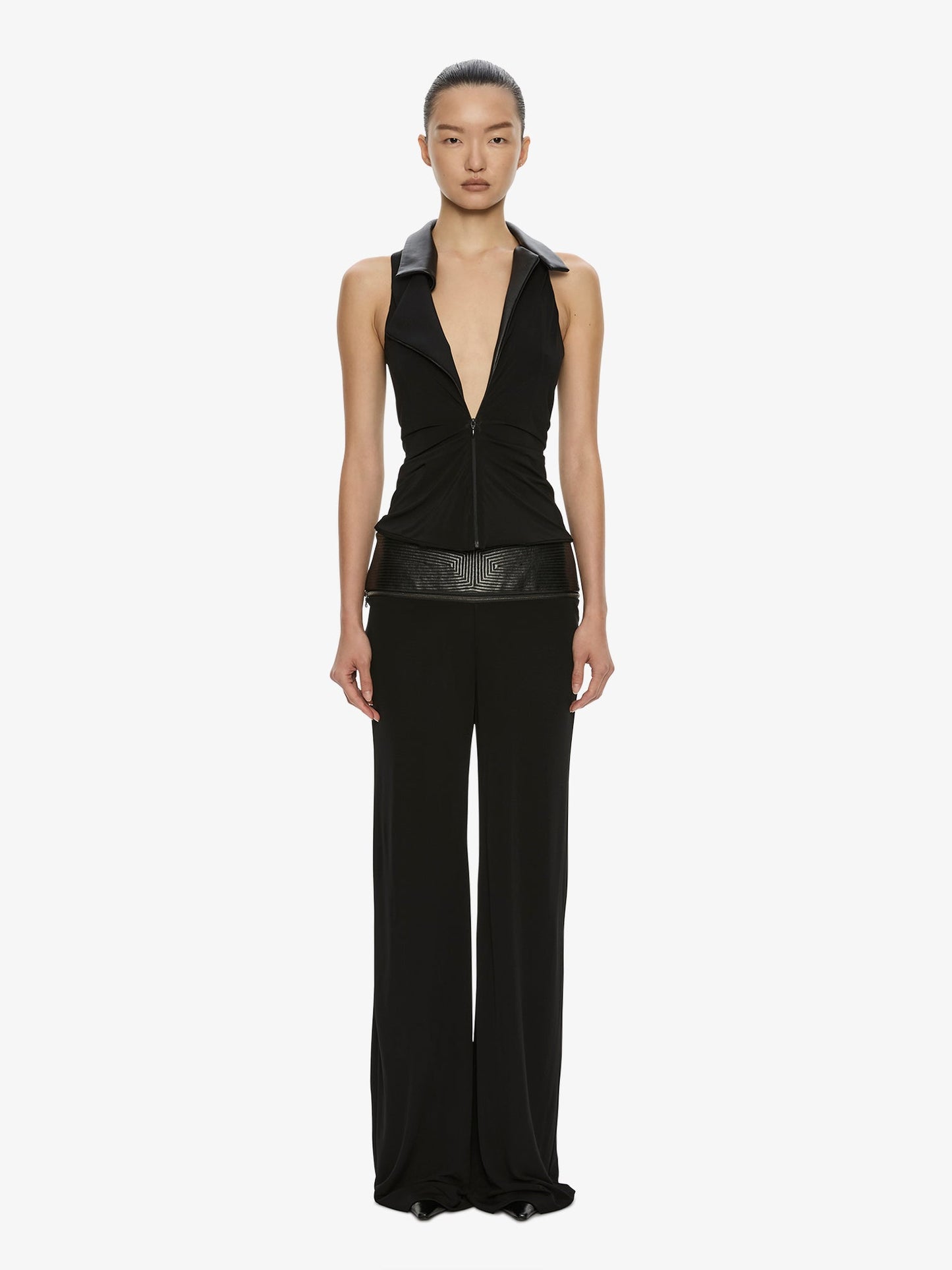 Image of a model wearing Pants. Product name - Auto Upholstered Leather Trouser in Black colour by brand - CHRISTOPHER ESBER
