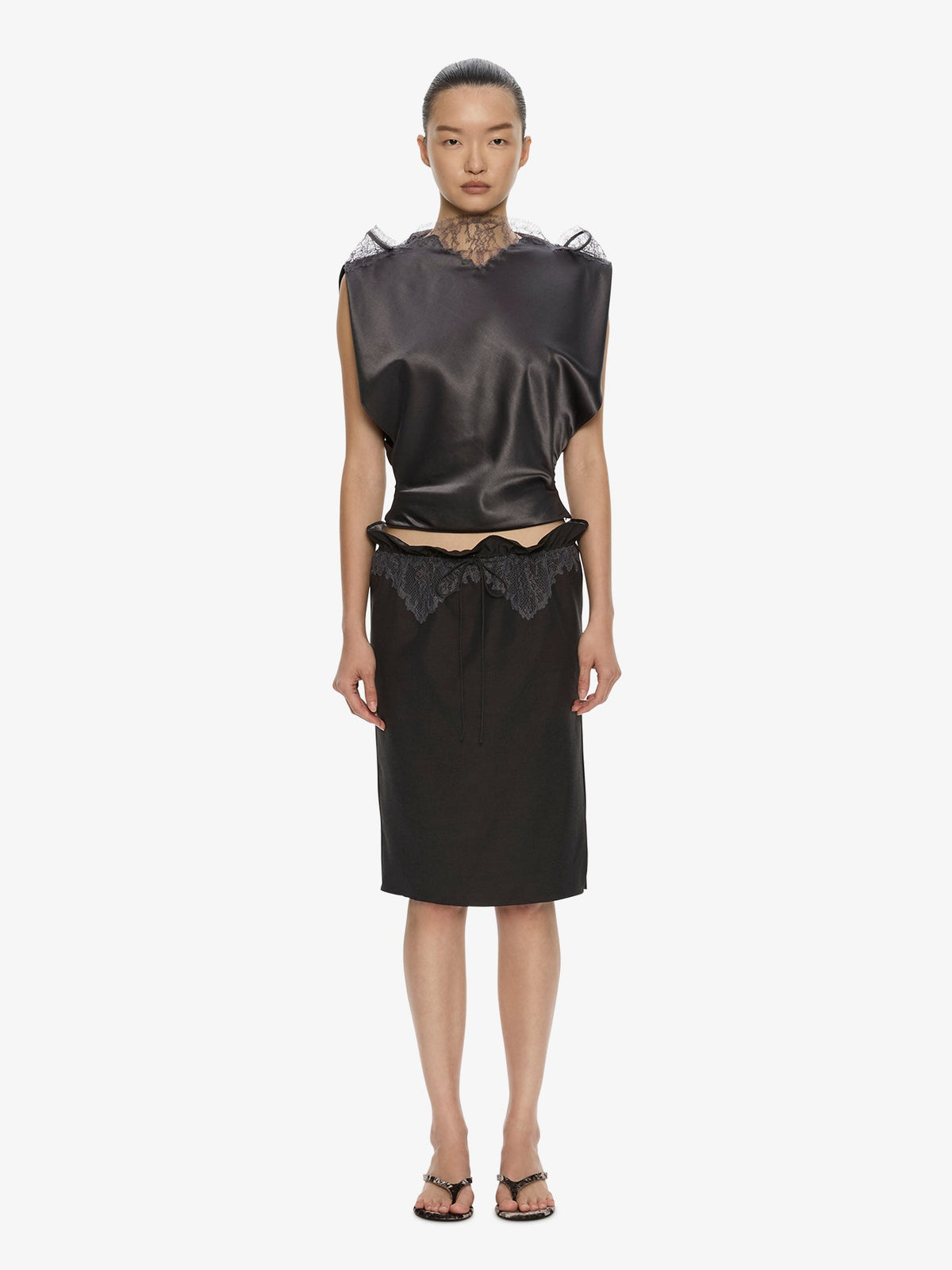 Image of a model wearing Skirts. Product name - Anais Lace Trimmed Tie Skirt in Smoke colour by brand - CHRISTOPHER ESBER