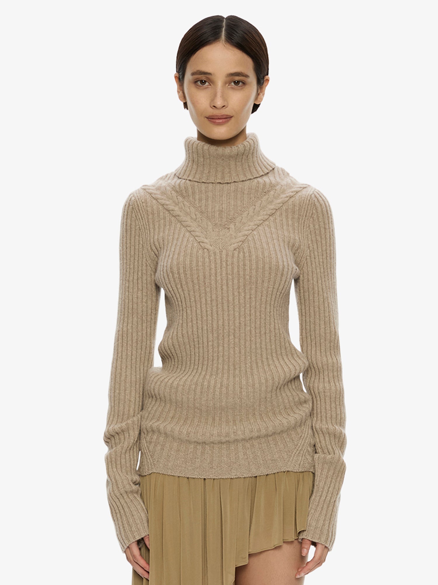 Image of a model wearing Tops. Product name - Caia Cable Knit Turtleneck in Jute colour by brand - CHRISTOPHER ESBER