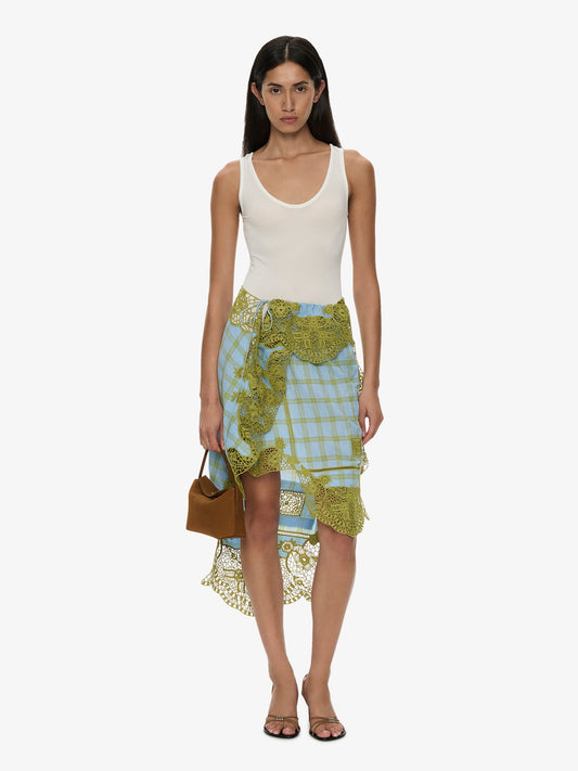 Image of a model wearing Skirts. Product name - Embroidered Handkerchief Envelope Midi Skirt in Check colour by brand - CHRISTOPHER ESBER