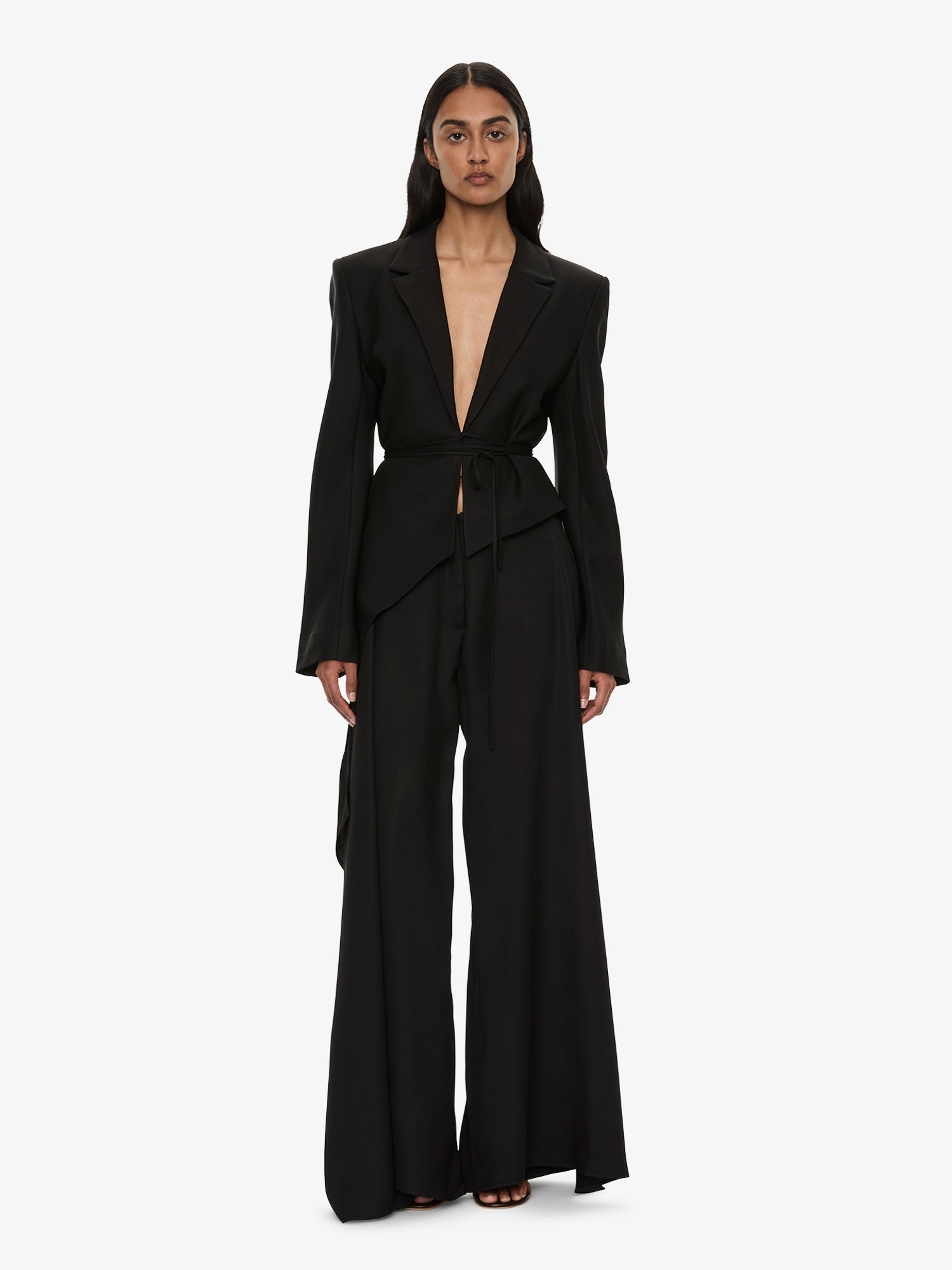 Image of a model wearing Pants. Product name - Released Towel Trouser in Black colour by brand - CHRISTOPHER ESBER