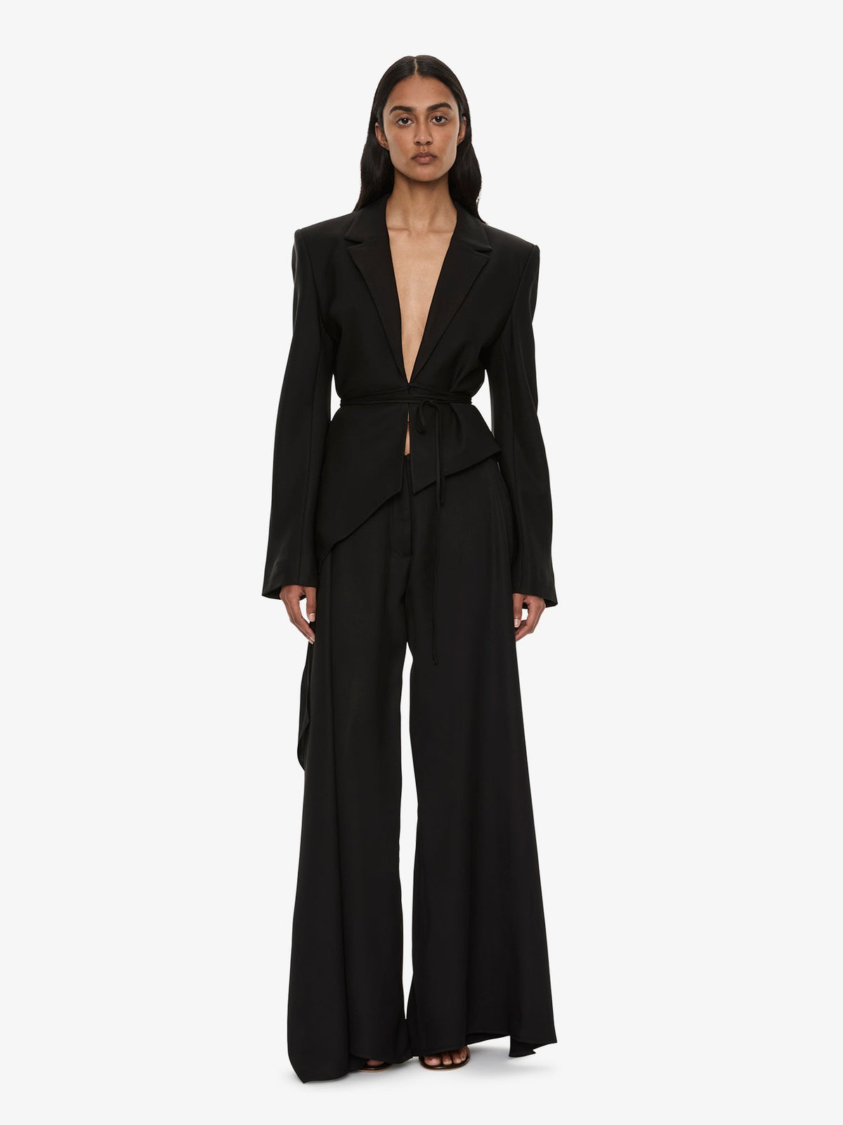 Image of a model wearing Pants. Product name - Released Towel Trouser in Black colour by brand - CHRISTOPHER ESBER