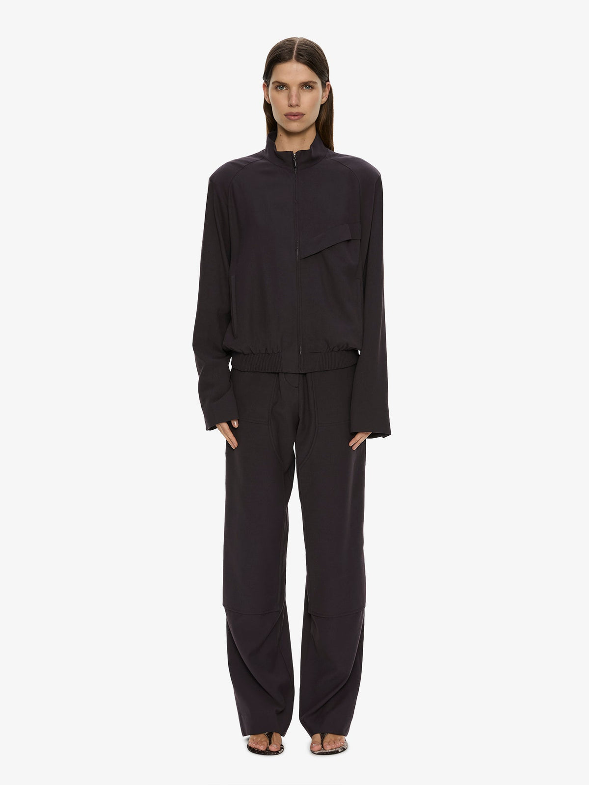 Image of a model wearing Pants. Product name - Utility Twill Trouser in Eggplant colour by brand - CHRISTOPHER ESBER