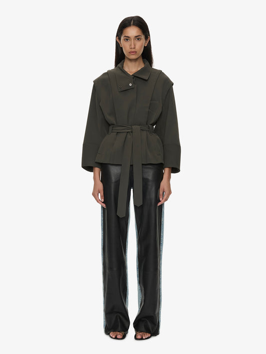 Image of a model wearing Outerwear. Product name - Virelle Parapet Drift Jacket in Green colour by brand - CHRISTOPHER ESBER