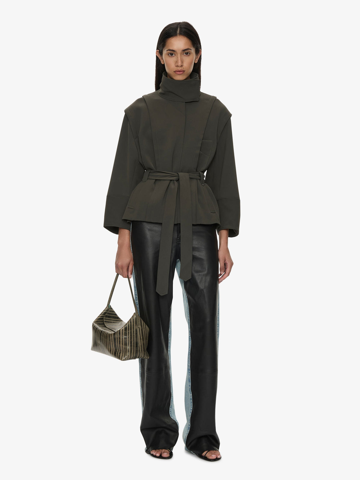 Image of a model wearing Outerwear. Product name - Virelle Parapet Drift Jacket in Green colour by brand - CHRISTOPHER ESBER