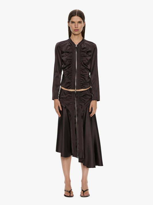 Image of a model wearing Skirts. Product name - Invert Silk Gwen Skirt in Molasses colour by brand - CHRISTOPHER ESBER
