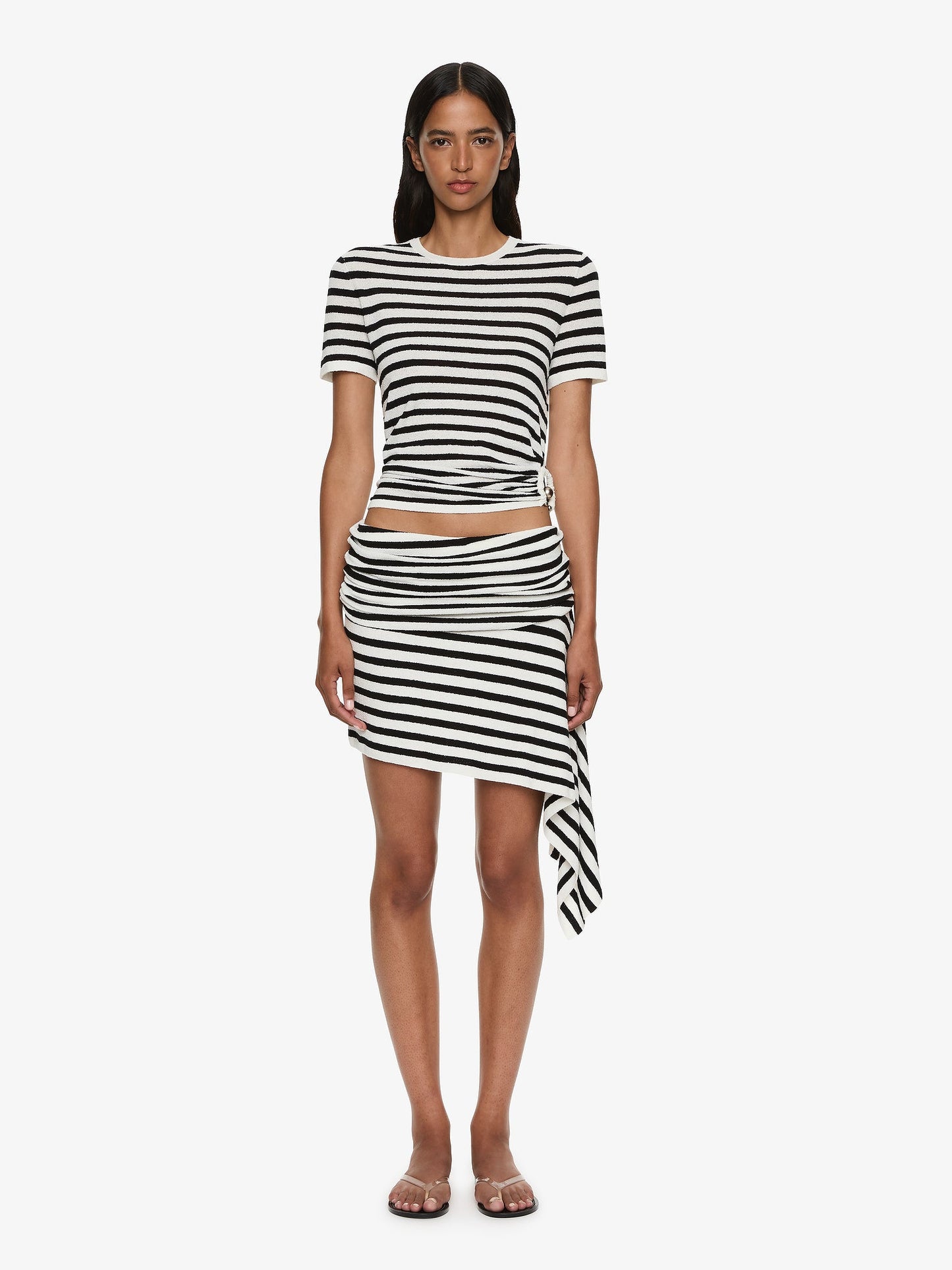 Image of a model wearing Skirts. Product name - Stripe Knit Extension Drape Mini Skirt in White colour by brand - CHRISTOPHER ESBER