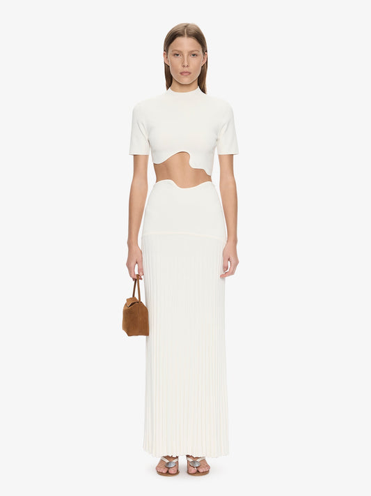 Image of a model wearing Skirts. Product name - Maparadita Pleated Skirt in White colour by brand - CHRISTOPHER ESBER