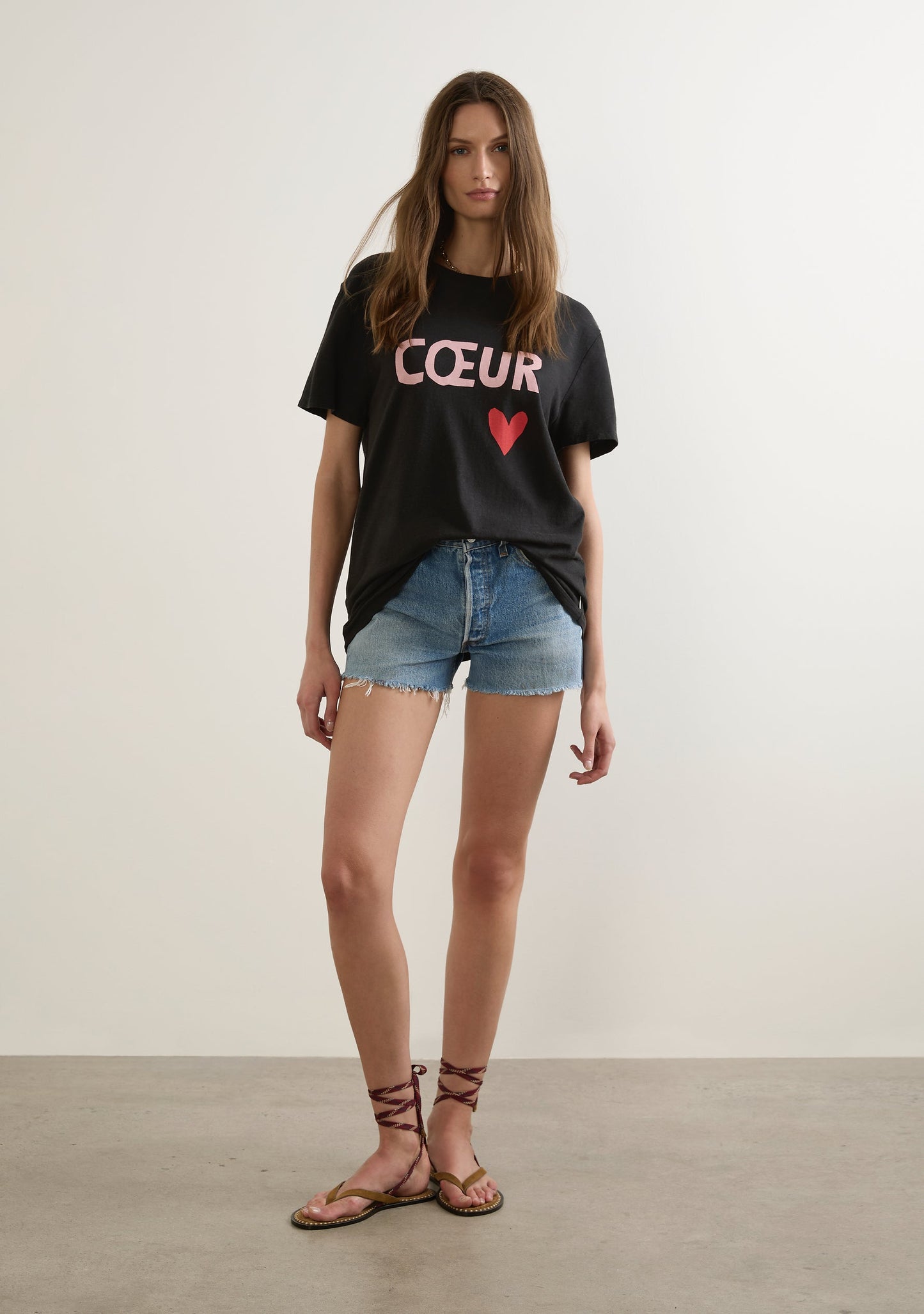Image of a model wearing Tops. Productname: Auguste The Label Heart Classic Tee in Black colour by brand - Auguste The Label