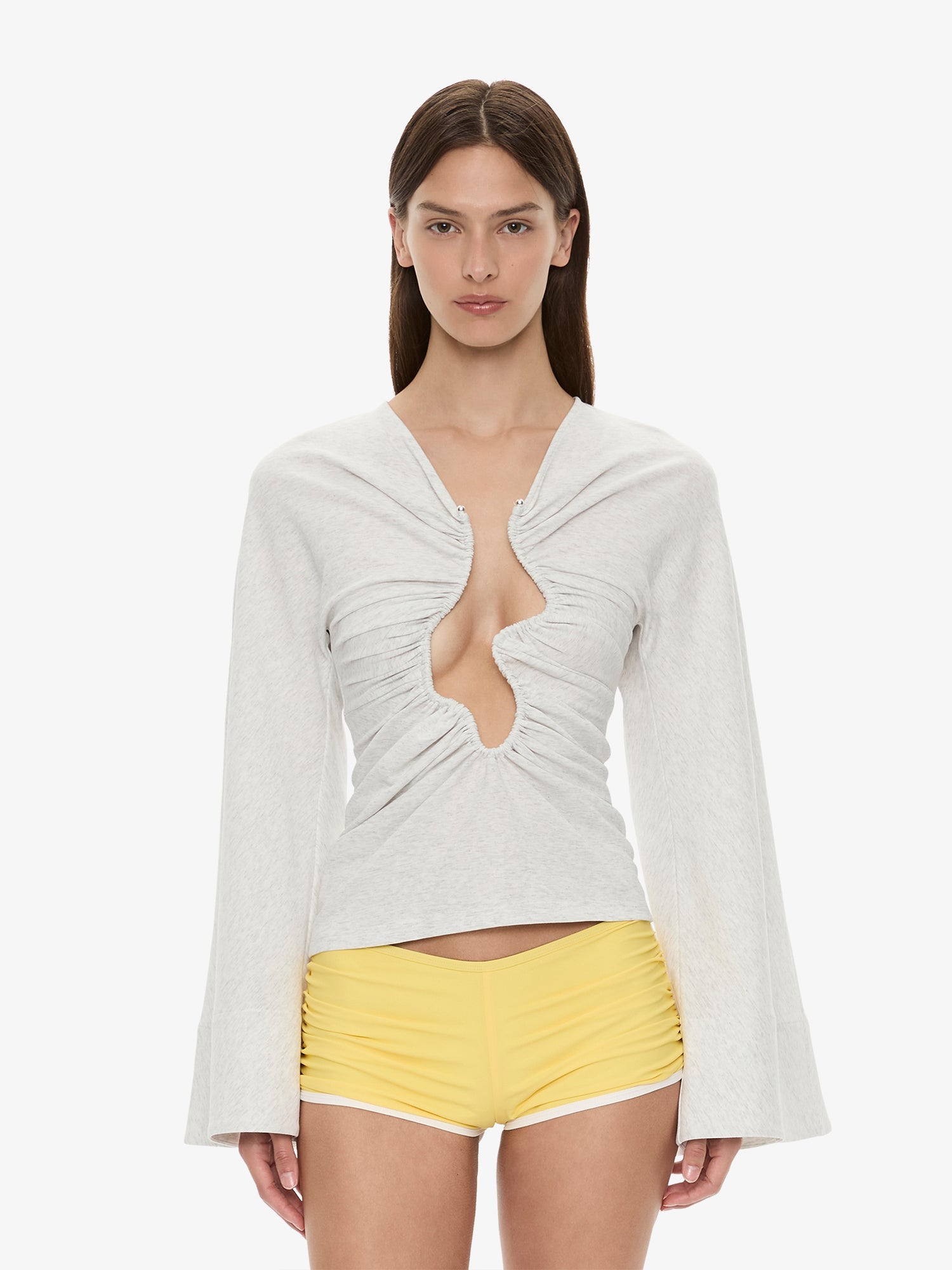 Image of a model wearing Tops. Product name - Salacia Ruched Long Sleeve Top in Marle colour by brand - CHRISTOPHER ESBER
