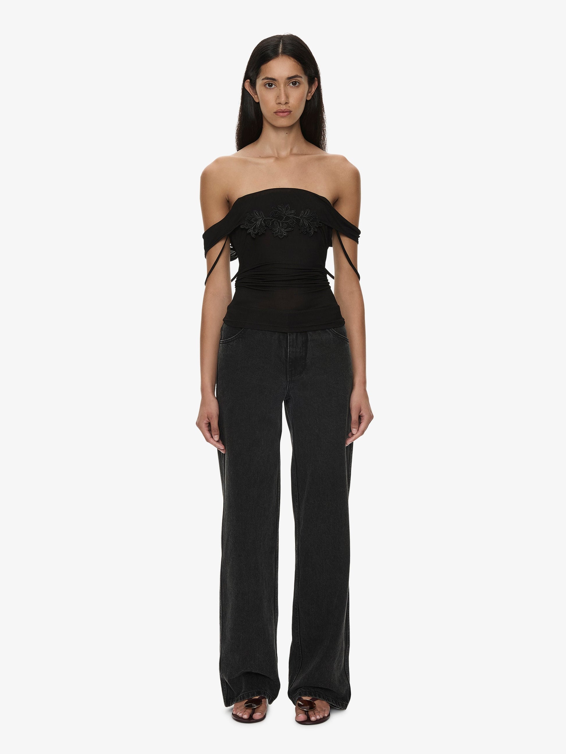 Image of a model wearing Tops. Product name - Hibiscus Embroidered Rib Foldover Cami in Black colour by brand - CHRISTOPHER ESBER