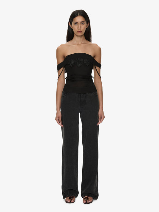 Image of a model wearing Tops. Product name - Hibiscus Embroidered Rib Foldover Cami in Black colour by brand - CHRISTOPHER ESBER