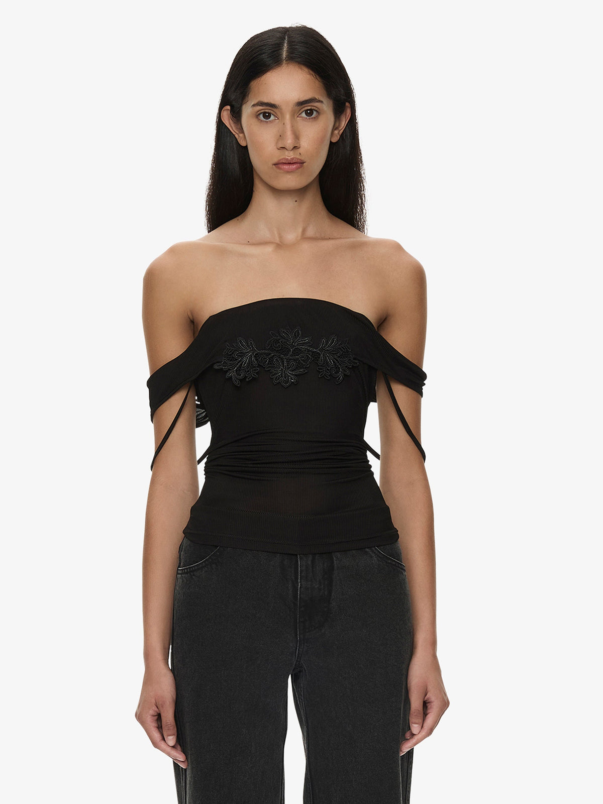 Image of a model wearing Tops. Product name - Hibiscus Embroidered Rib Foldover Cami in Black colour by brand - CHRISTOPHER ESBER