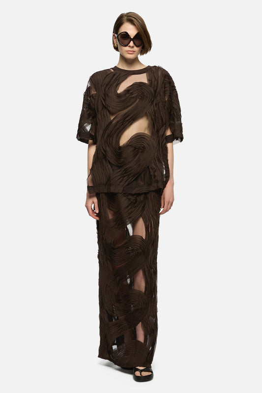 Image of a model wearing Skirts. Product name - Delmare Skirt Brown in Brown colour by brand - Blanca Studio