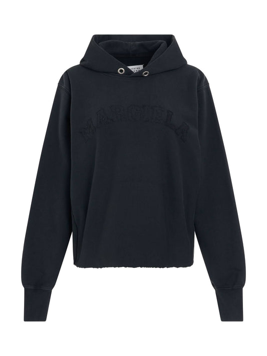 Image of a model wearing Outerwear. Productname: MAISON MARGIELA Memory Logo Hoodie in Black colour by brand - MAISON MARGIELA