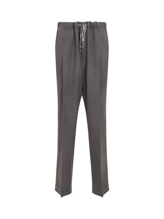 Image of a model wearing Pants. Productname: MAISON MARGIELA Wool Trousers in Grey colour by brand - MAISON MARGIELA