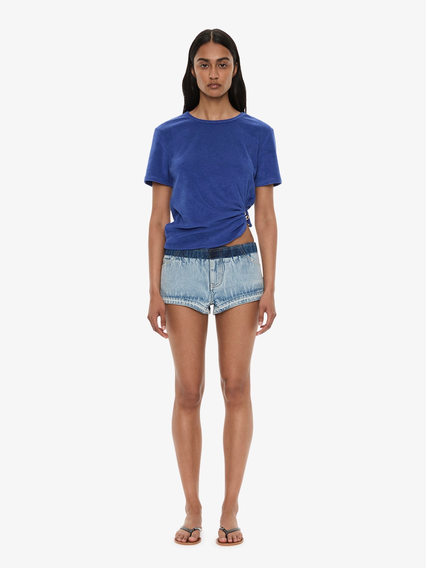 Image of a model wearing Shorts. Product name - Reconstruct Denim Micro Short in Indigo colour by brand - CHRISTOPHER ESBER