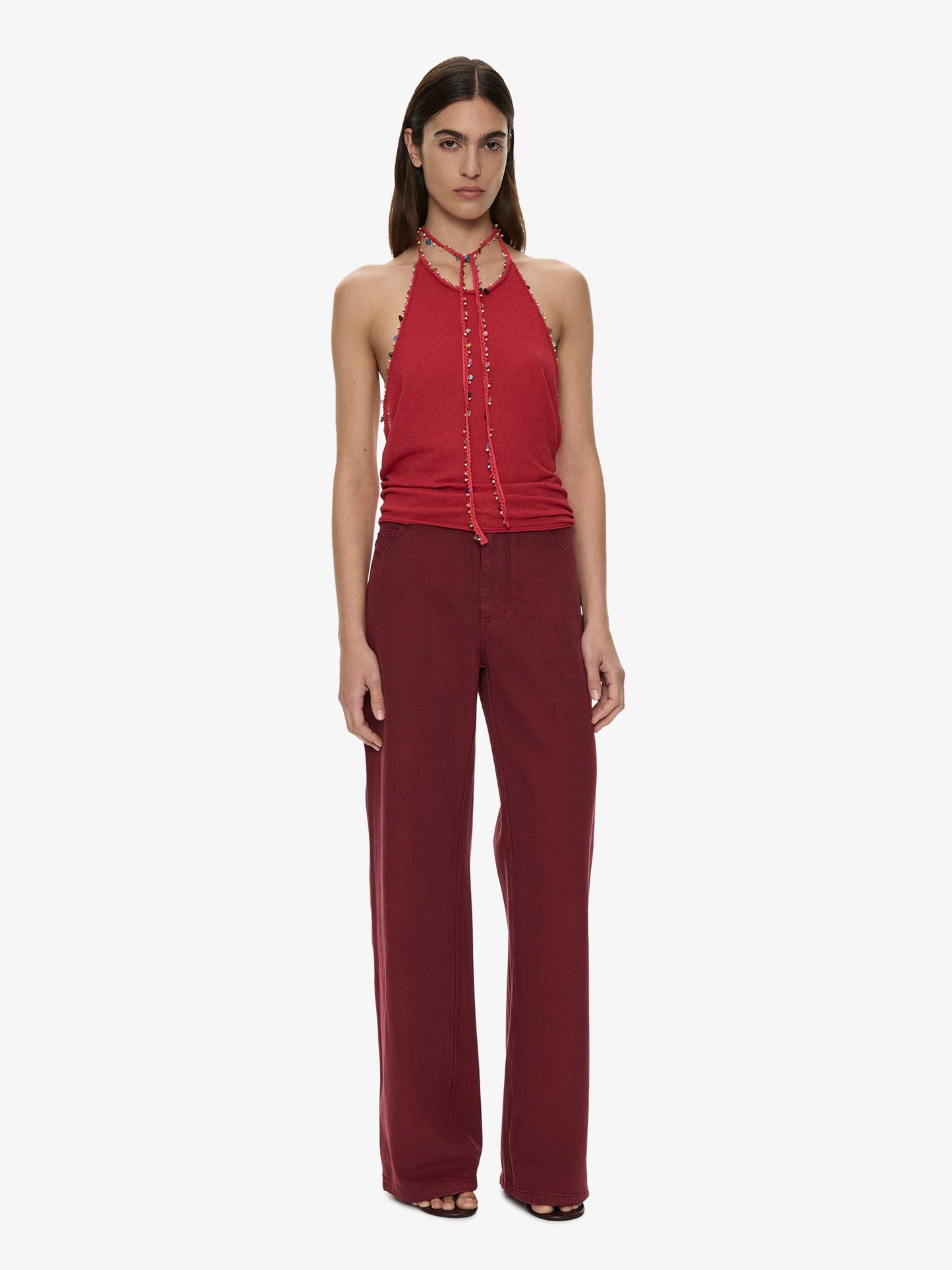 Image of a model wearing Pants. Product name - Relaxed Denim Quartz Jean in Wine colour by brand - CHRISTOPHER ESBER