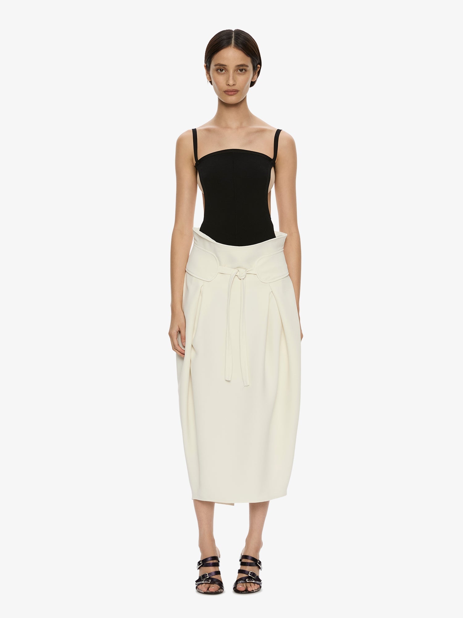 Image of a model wearing Skirts. Product name - Virelle Cocoon Skirt in Cream colour by brand - CHRISTOPHER ESBER