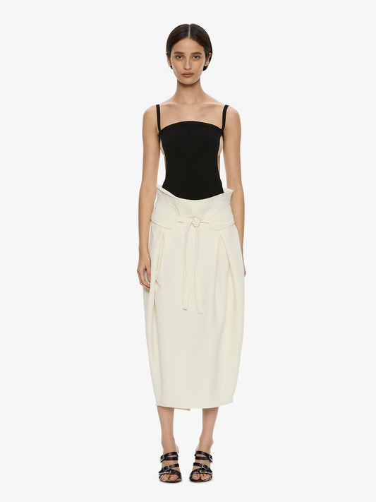 Image of a model wearing Skirts. Product name - Virelle Cocoon Skirt in Cream colour by brand - CHRISTOPHER ESBER